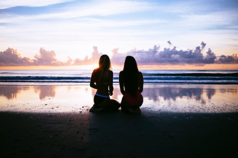 girls-sitting-on-the-beach